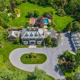 an aerial view of a house with garden space and street view
