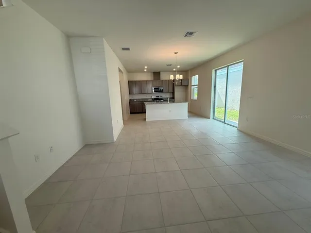 a view of a electric appliances in kitchen and livingroom with furniture