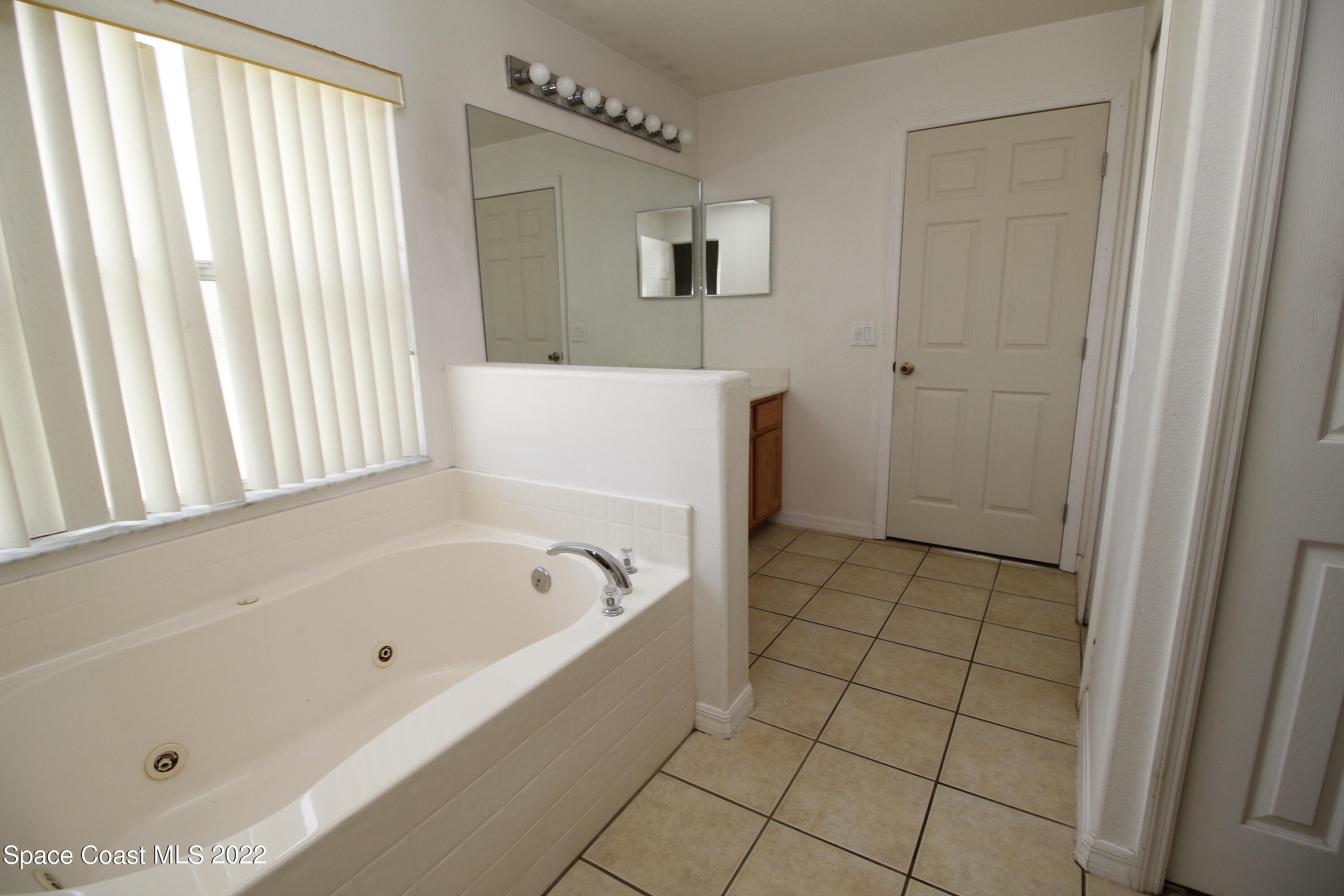 846 Walpole Road Southwest Palm Bay, FL 32908 - Photo 11 of 15 a bathroom with a bathtub and a shower