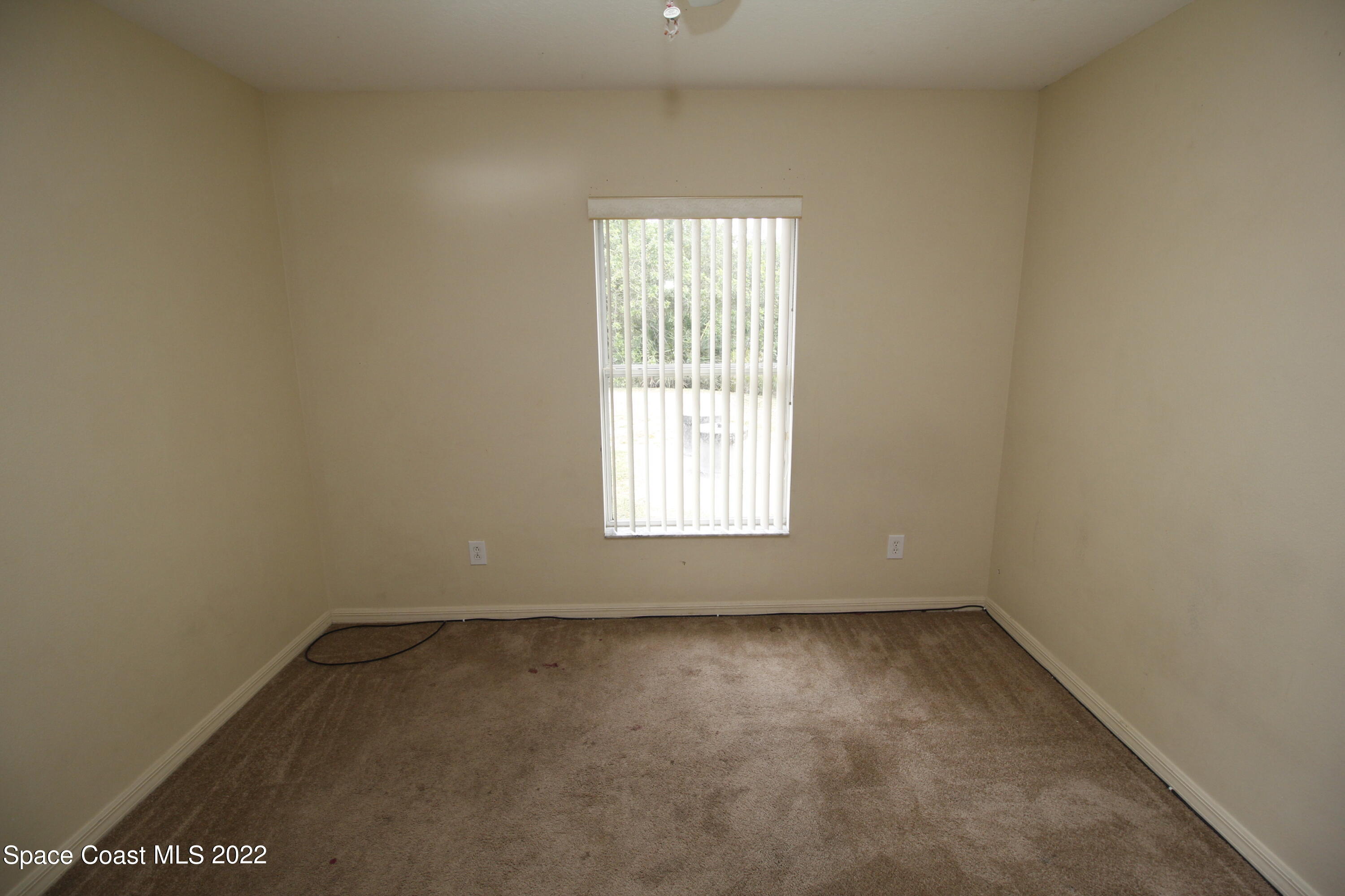 846 Walpole Road Southwest Palm Bay, FL 32908 - Photo 14 of 15 an empty room with a window