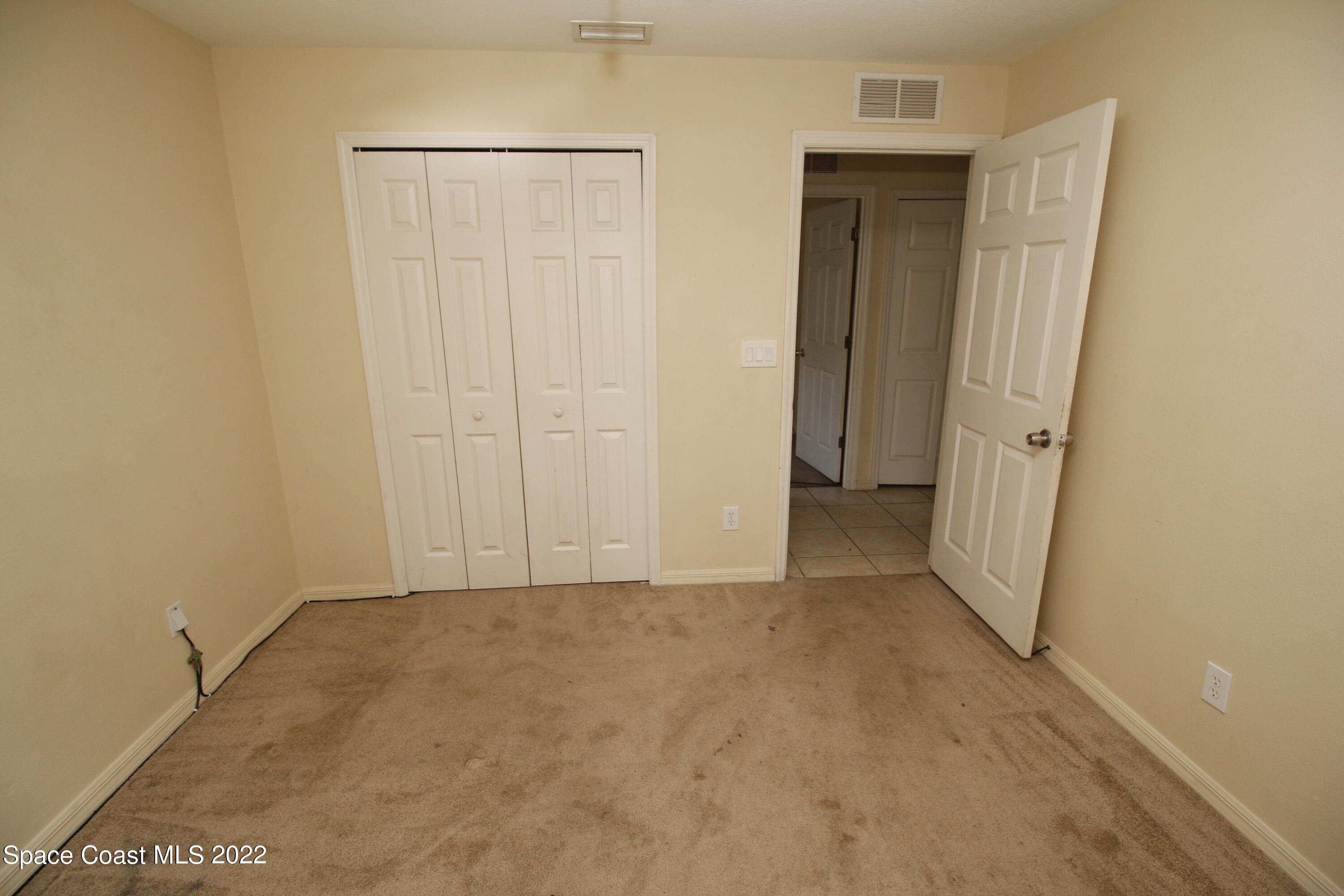 846 Walpole Road Southwest Palm Bay, FL 32908 - Photo 15 of 15 an empty room with a wooden door