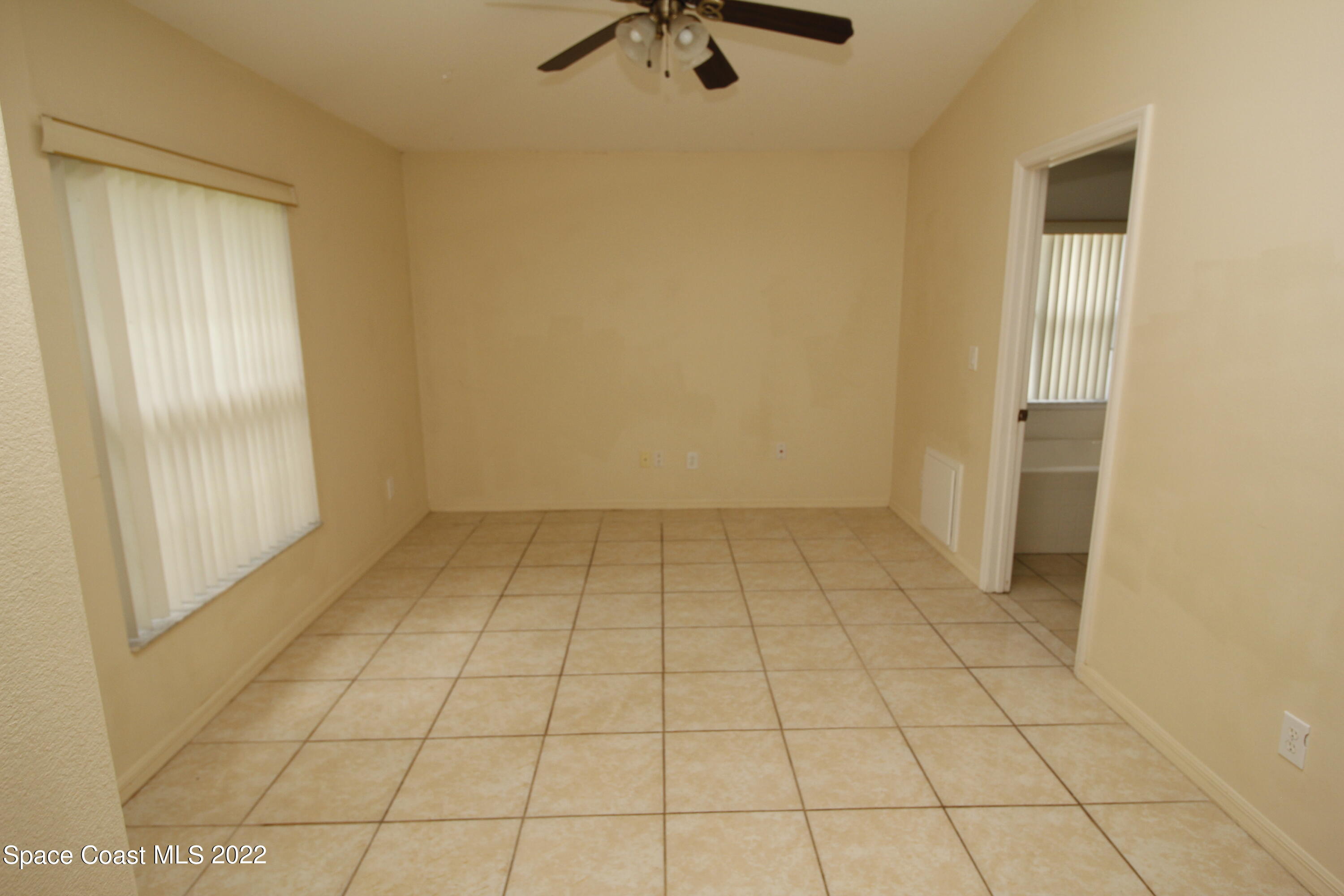 846 Walpole Road Southwest Palm Bay, FL 32908 - Photo 2 of 15 a view of a livingroom with an empty space and a window