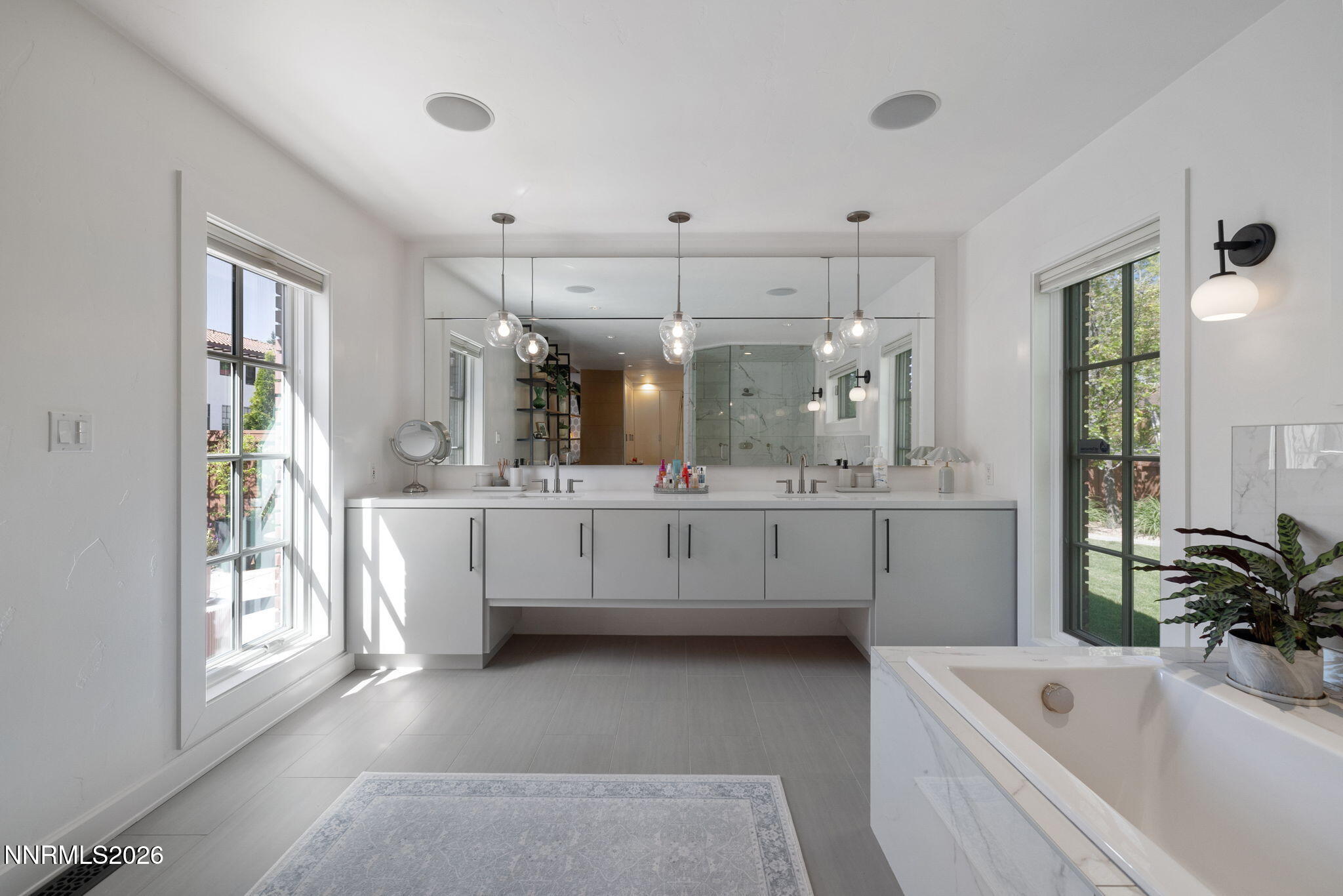 210 Bret Harte Avenue Reno, NV 89509 - Photo 18 of 40 a bathroom with a tub a sink a mirror and a shower