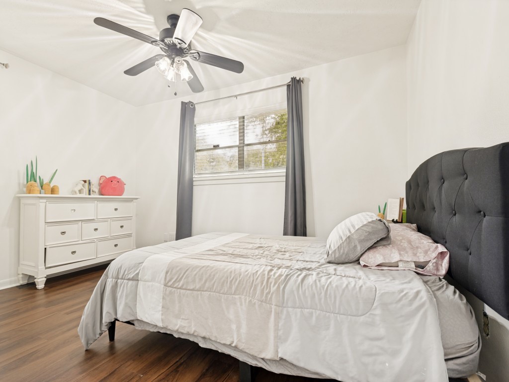 124 Bluebird Lane Pasadena, TX 77502 - Photo 20 of 25 a bedroom with a bed and a chandelier