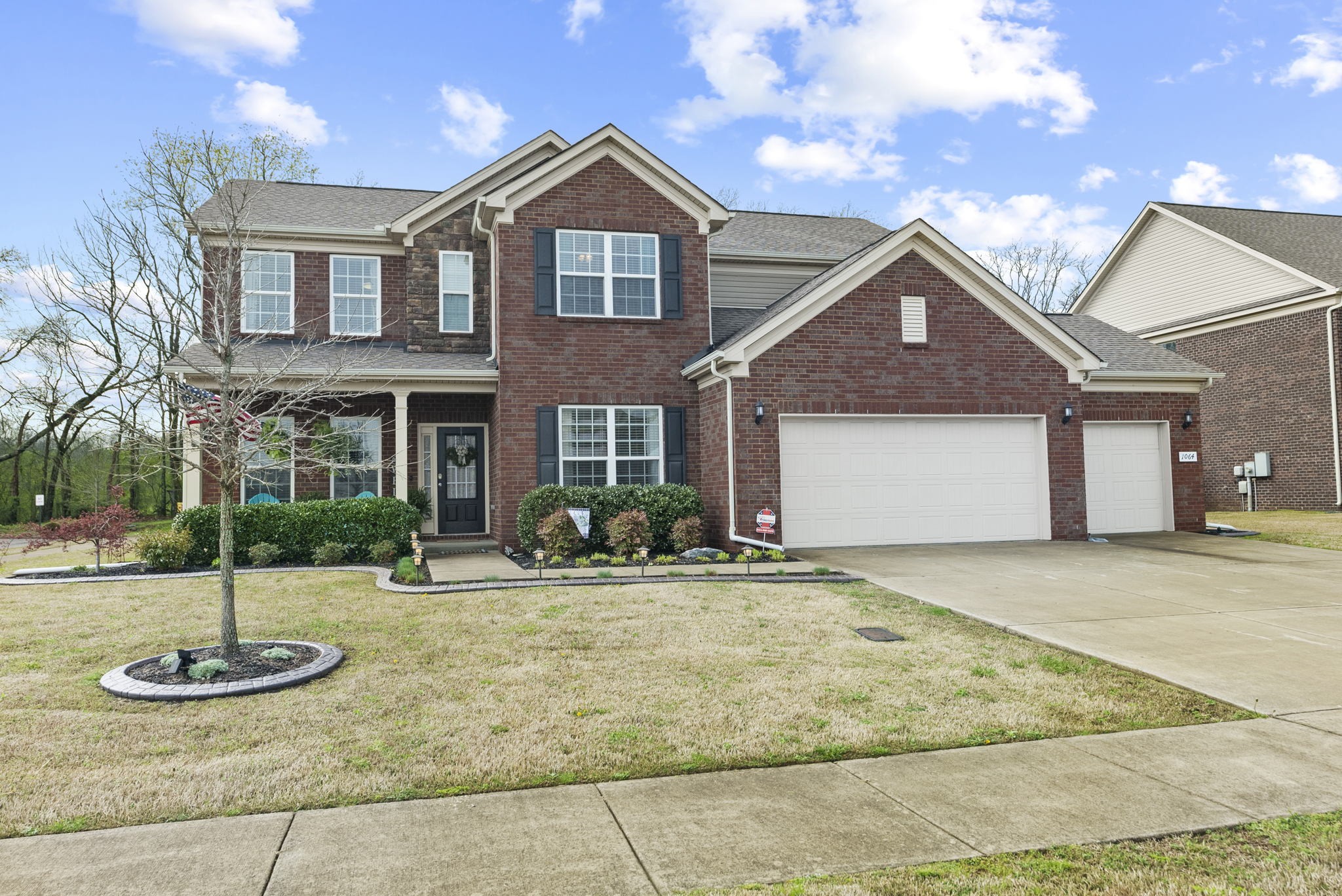 1064 Addington Road Hendersonville, TN 37075 - Photo 1 of 55 a front view of a house with garden and plants