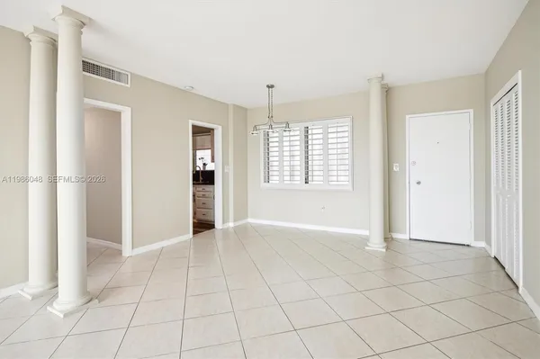 an empty room with windows and closet