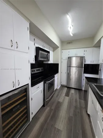 a kitchen with a refrigerator and a stove