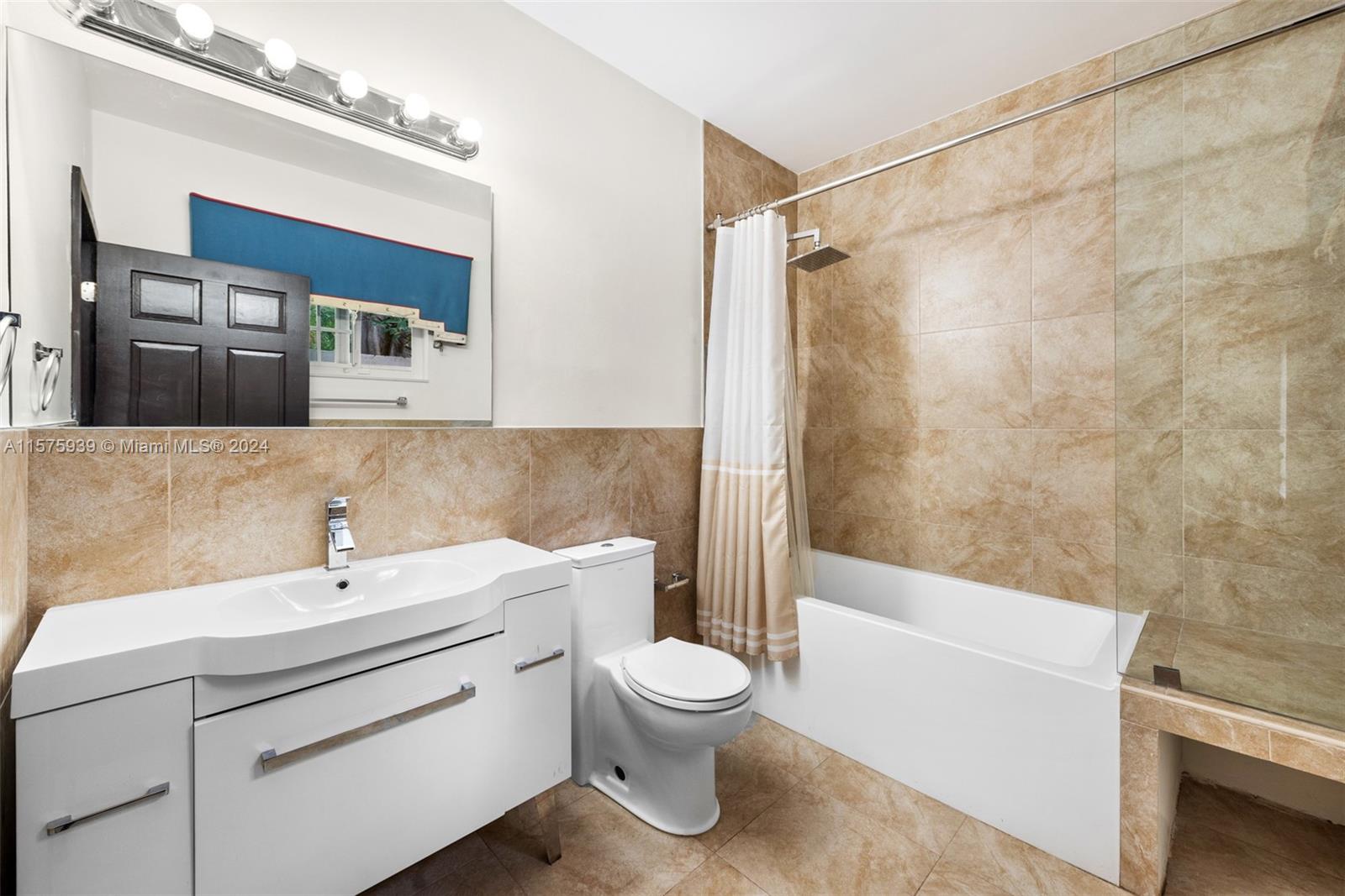 2811 Southwest 22nd Avenue Miami, FL 33133 - Photo 29 of 39 a bathroom with a sink a toilet and shower