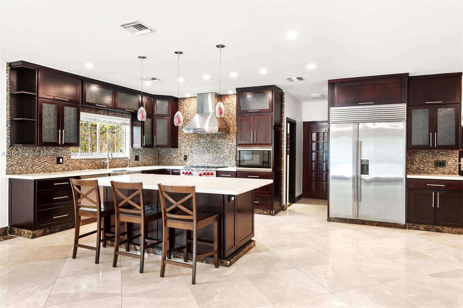 2811 Southwest 22nd Avenue Miami, FL 33133 - Photo 3 of 39 a large kitchen with a table and chairs