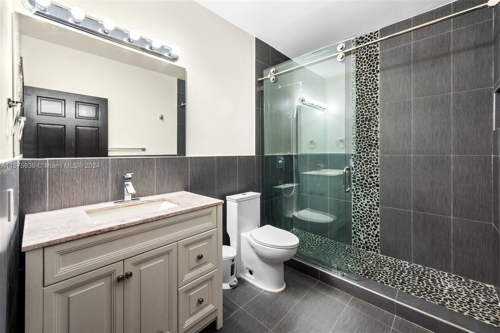 2811 Southwest 22nd Avenue Miami, FL 33133 - Photo 31 of 39 a bathroom with a sink a toilet and shower