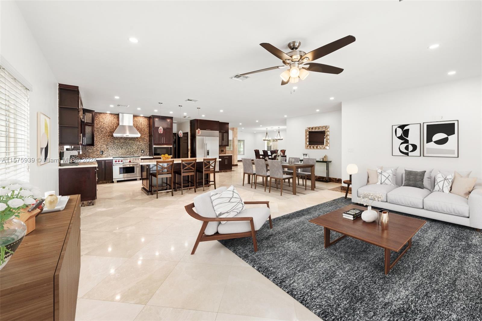 2811 Southwest 22nd Avenue Miami, FL 33133 - Photo 4 of 39 a living room with furniture kitchen view and a chandelier