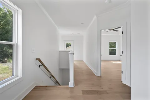 an entryway with a floor to ceiling window and a living room