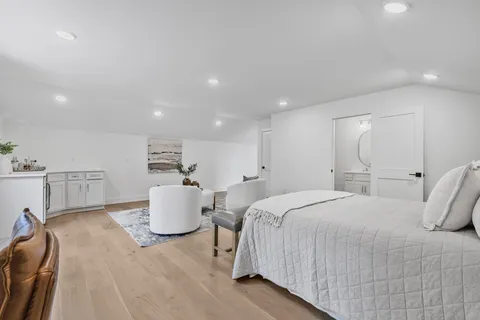 a bedroom with a bed and a couch