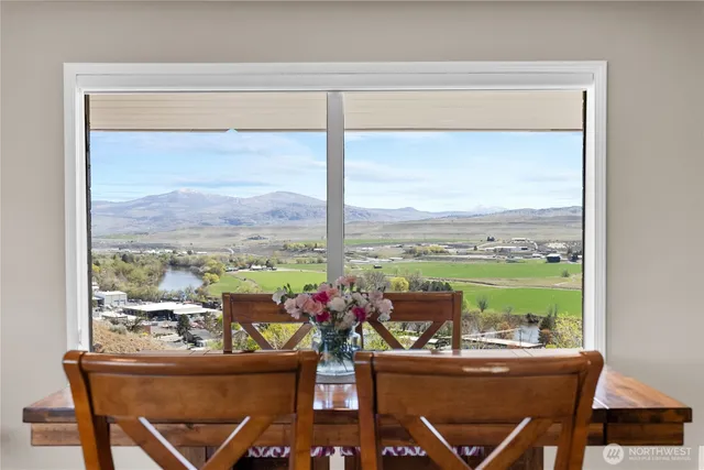 a dining room with furniture a rug and wooden floor
