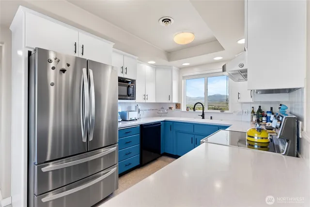 a kitchen with stainless steel appliances a sink a stove and cabinets