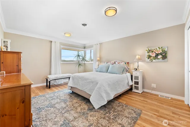 a bedroom with a bed and a large window