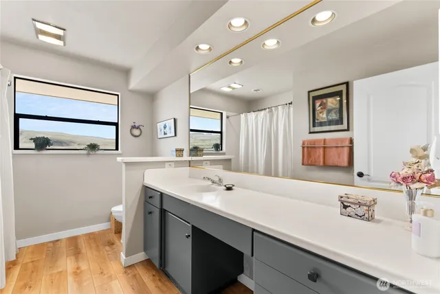 a bathroom with a sink a mirror and a window