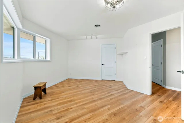 a bedroom with furniture and a large window
