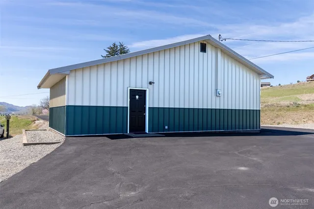 a view of a room with gym equipment and windows