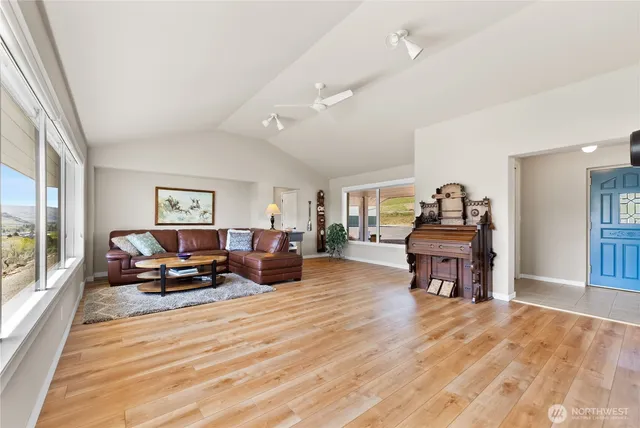a living room with furniture and a wooden floor