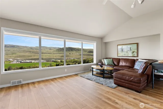a living room with furniture and large windows