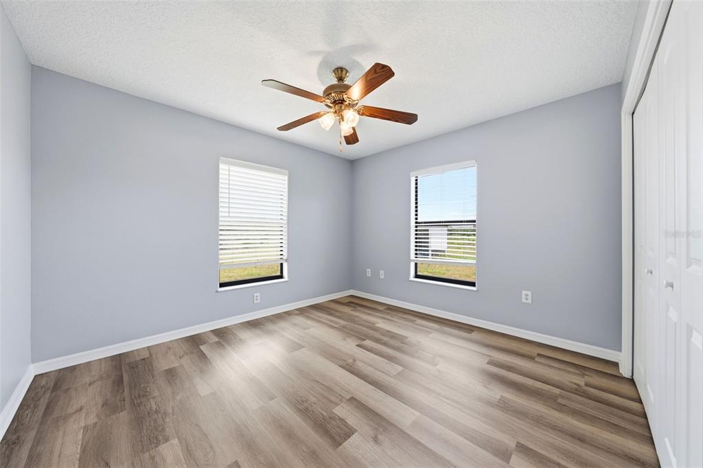 14433 Lake Yale Road Umatilla, FL 32784 - Photo 18 of 38 a view of an empty room with window and wooden floor