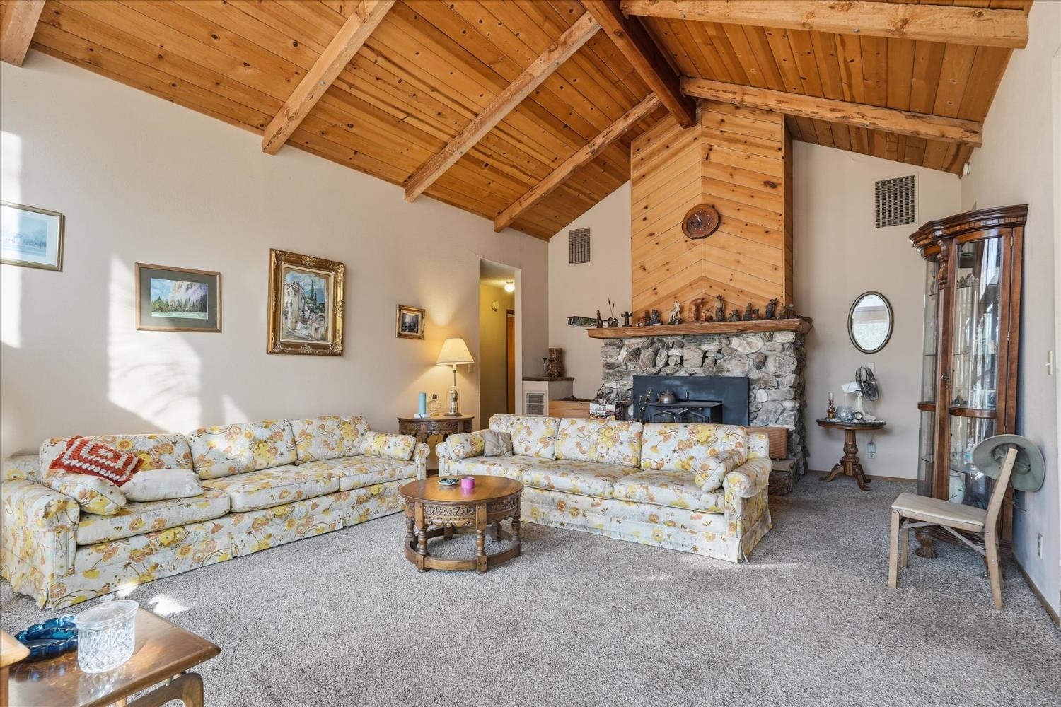 51590 Coyote Ridge Road Oakhurst, CA 93644 - Photo 11 of 49 a living room with furniture and a large window