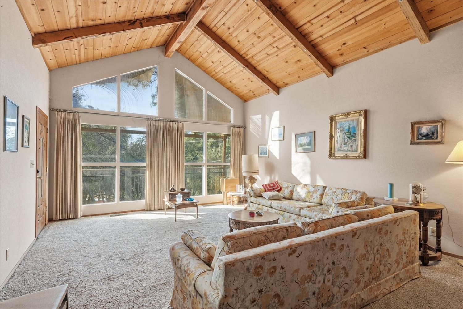 51590 Coyote Ridge Road Oakhurst, CA 93644 - Photo 12 of 49 a living room with furniture and large windows