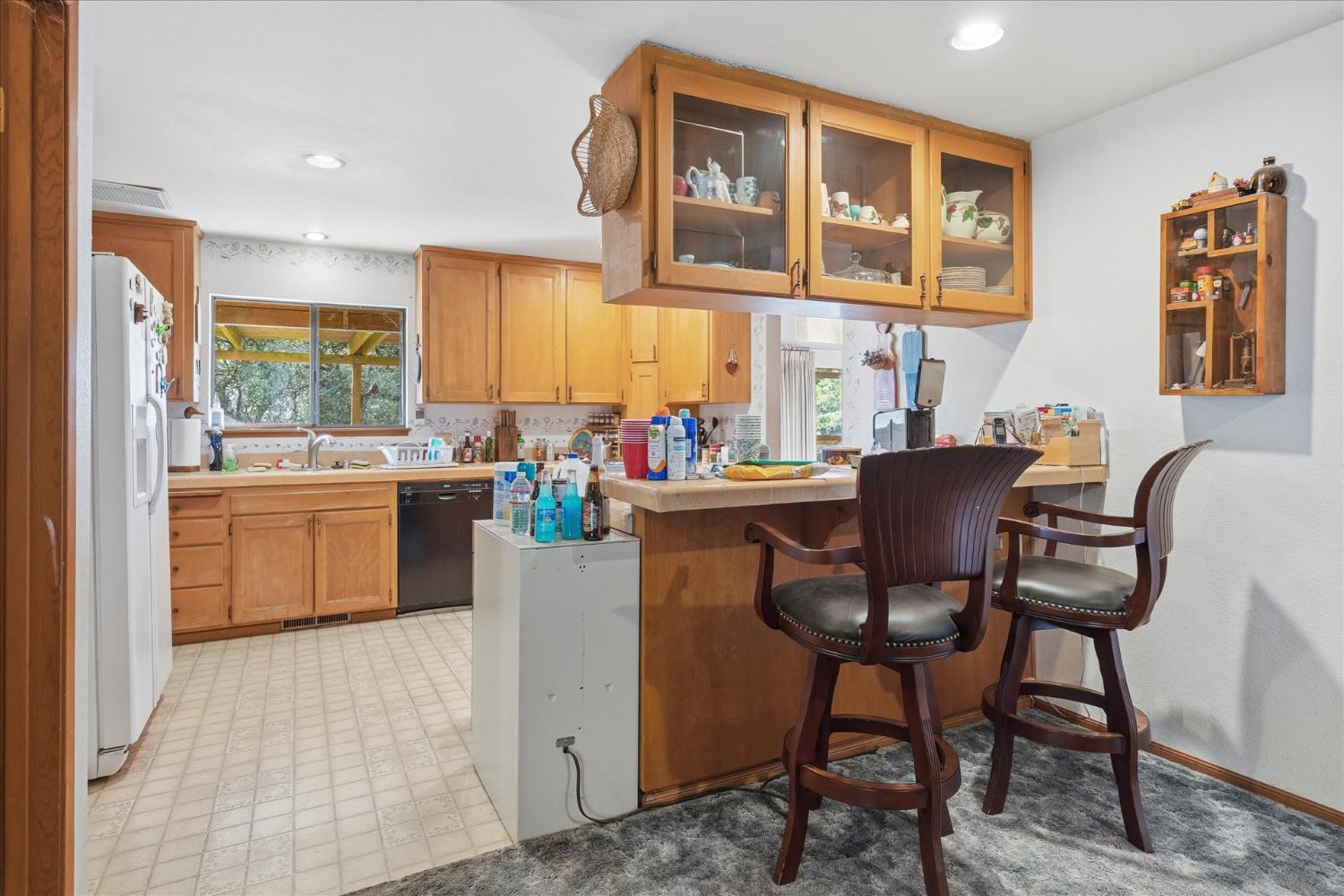 51590 Coyote Ridge Road Oakhurst, CA 93644 - Photo 15 of 49 a view of a dining room with furniture window and wooden floor