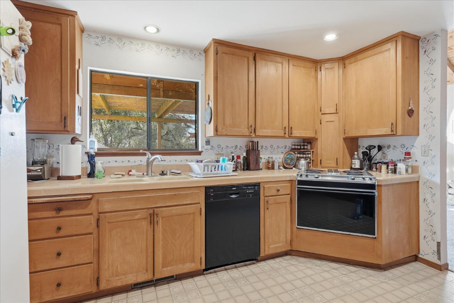 51590 Coyote Ridge Road Oakhurst, CA 93644 - Photo 16 of 49 a kitchen with stainless steel appliances granite countertop a sink and cabinets
