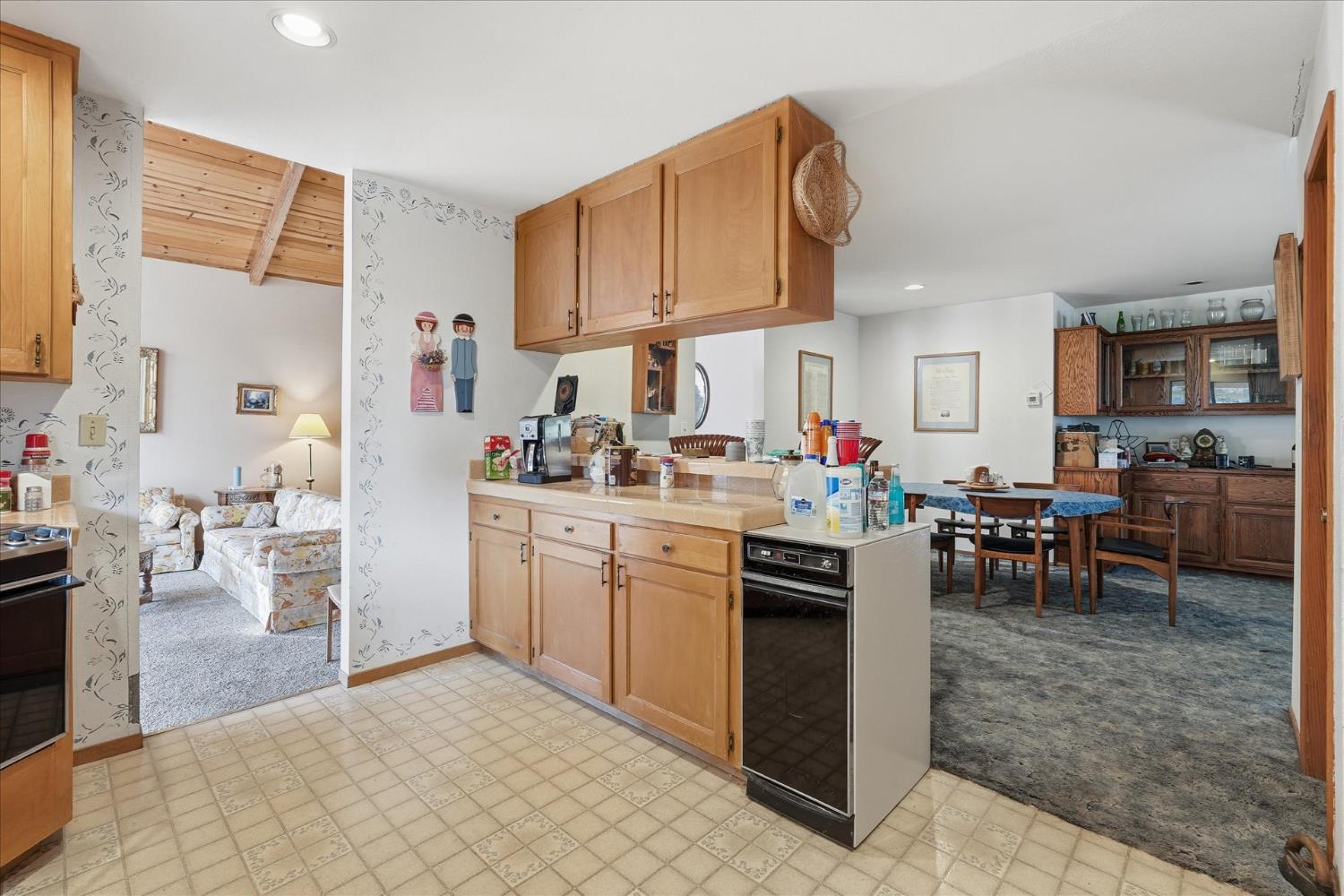 51590 Coyote Ridge Road Oakhurst, CA 93644 - Photo 17 of 49 a kitchen with white cabinets and chairs