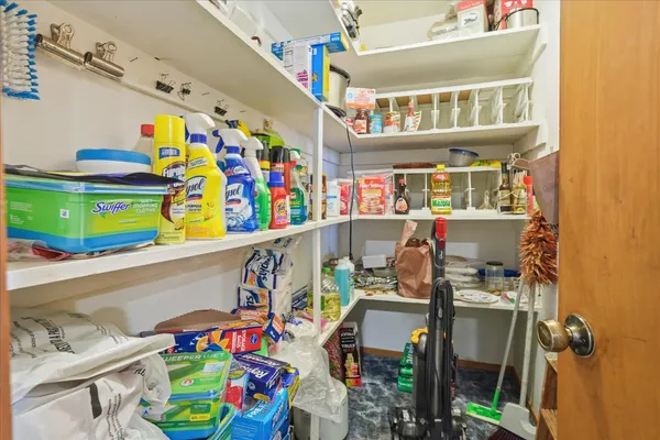 a bedroom with a bed and a dresser with mirror