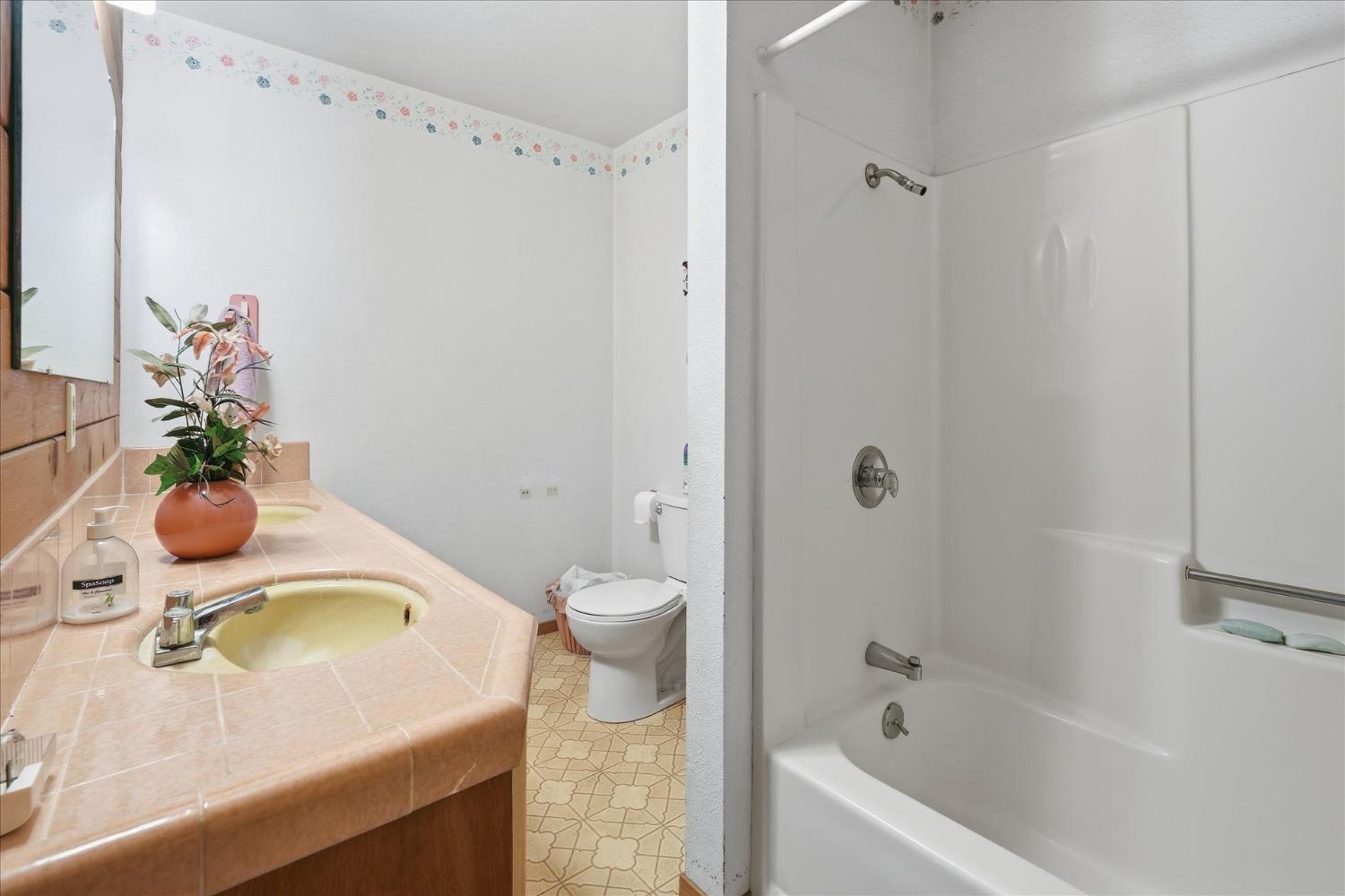 51590 Coyote Ridge Road Oakhurst, CA 93644 - Photo 28 of 49 a bathroom with a sink a toilet and shower