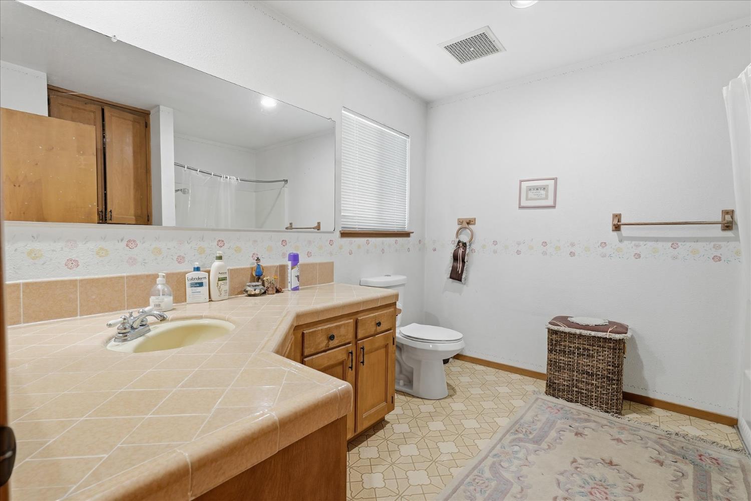 51590 Coyote Ridge Road Oakhurst, CA 93644 - Photo 32 of 49 a bathroom with a sink toilet and mirror