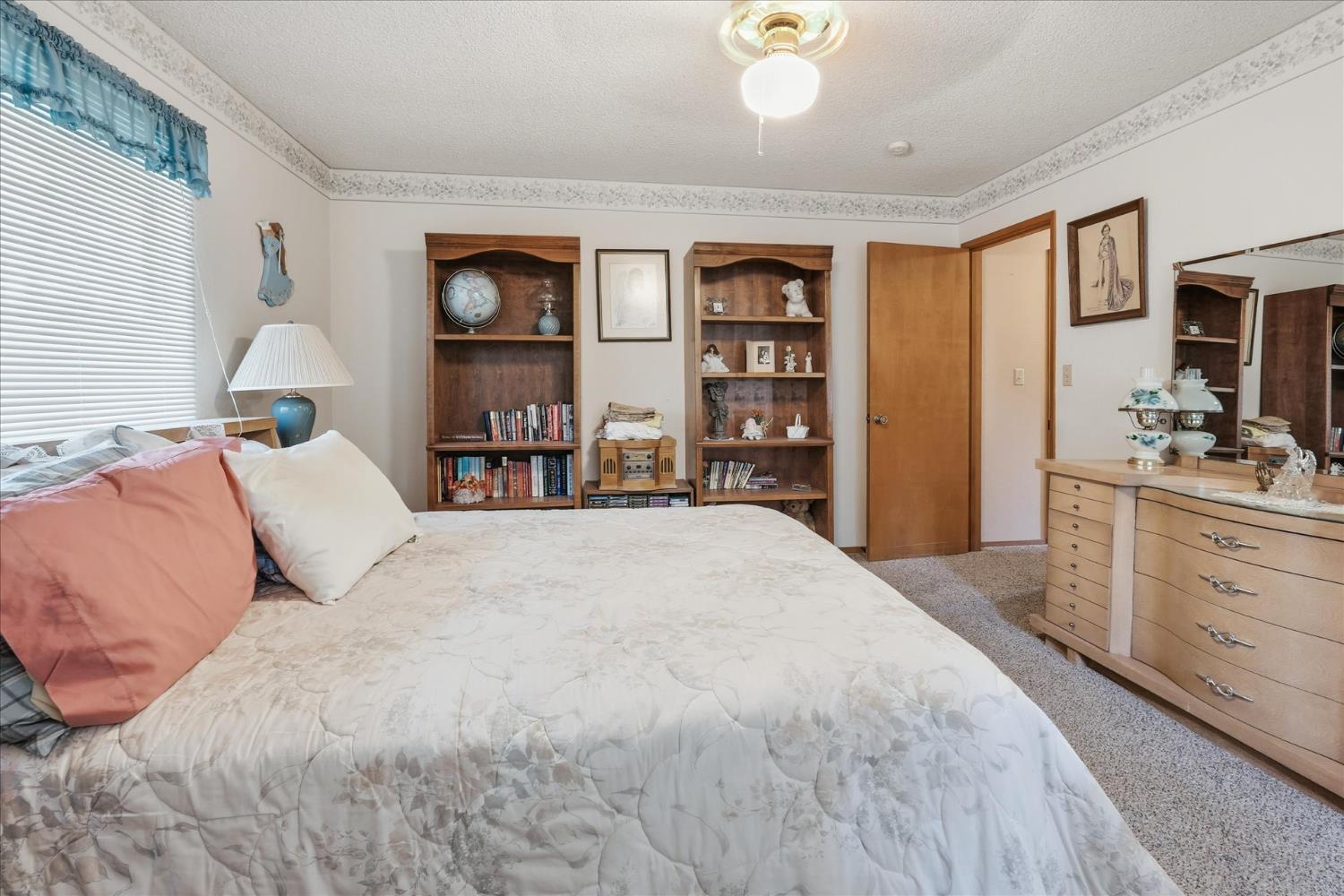 51590 Coyote Ridge Road Oakhurst, CA 93644 - Photo 35 of 49 a spacious bedroom with a large bed and a dresser