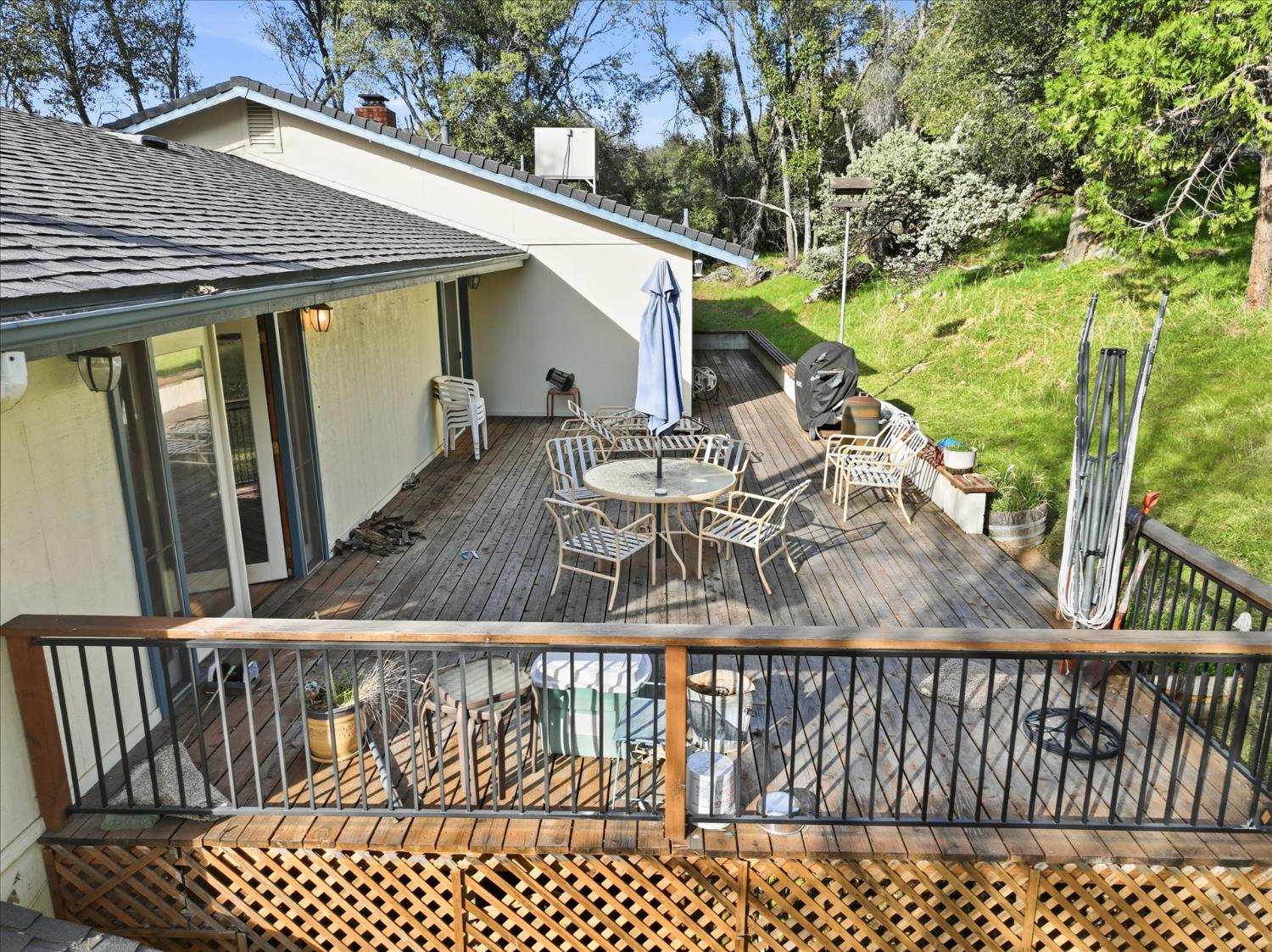 51590 Coyote Ridge Road Oakhurst, CA 93644 - Photo 41 of 49 a view of a patio with a table and chairs