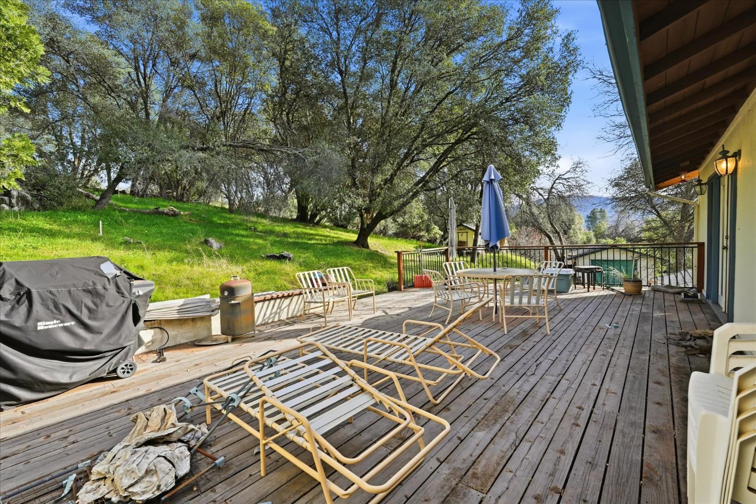 51590 Coyote Ridge Road Oakhurst, CA 93644 - Photo 44 of 49 a view of outdoor space deck kitchen and outdoor seating