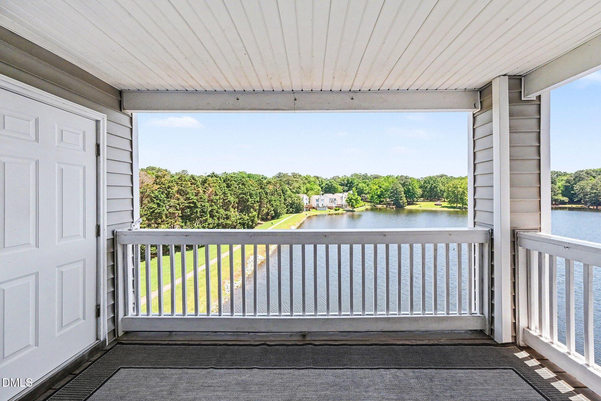 132 Springfork Drive Cary, NC 27513 - Photo 6 of 28 a view of a porch with a floor to ceiling window and a forest