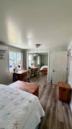 a bedroom with furniture and a large window