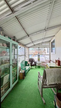 a view of a porch in the backyard