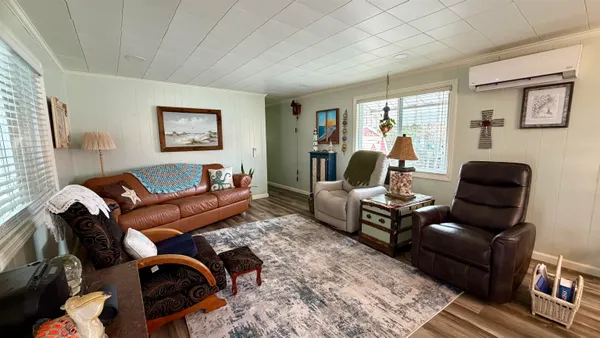 a living room with furniture rug and wooden floor