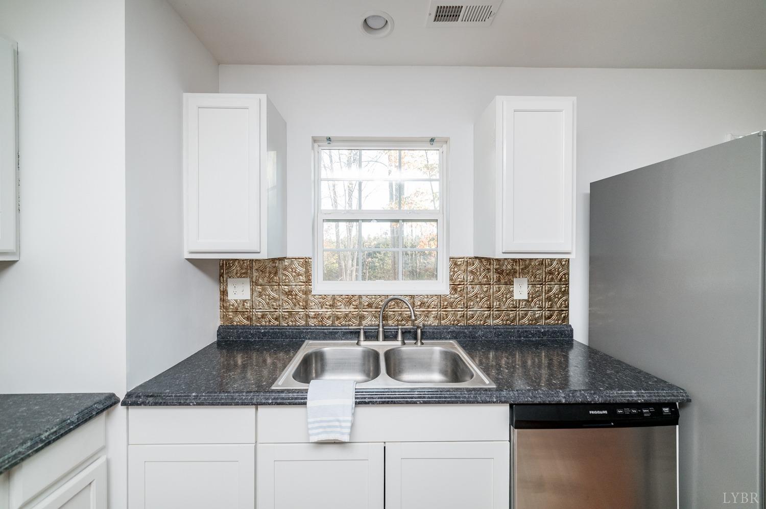 538 Spring Grove Road Spout Spring, VA 24593 - Photo 12 of 44 a kitchen with granite countertop a sink and a window