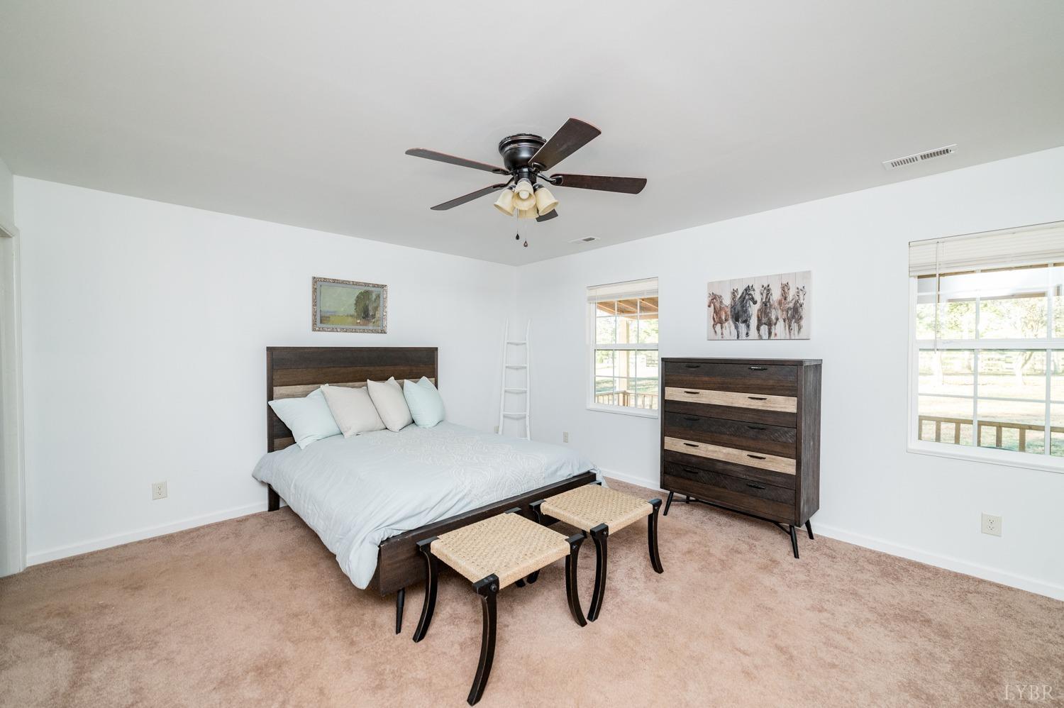 538 Spring Grove Road Spout Spring, VA 24593 - Photo 21 of 44 a bedroom with a bed and a chandelier