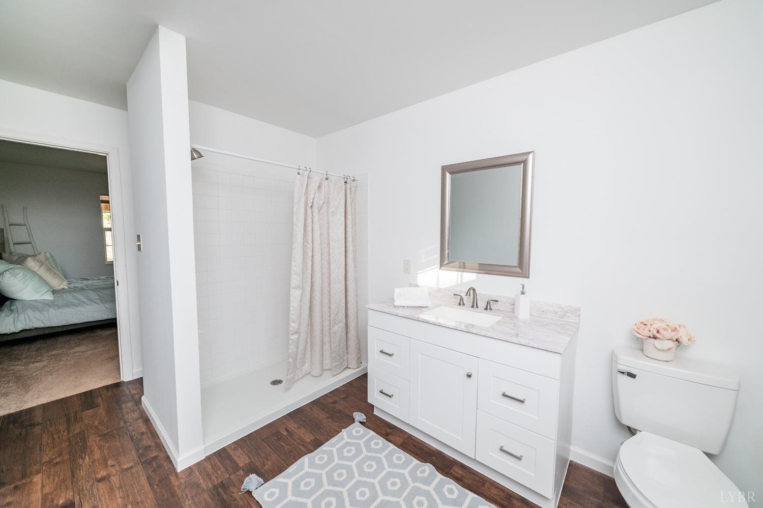 538 Spring Grove Road Spout Spring, VA 24593 - Photo 25 of 44 a en suite bathroom with a granite countertop sink and a mirror