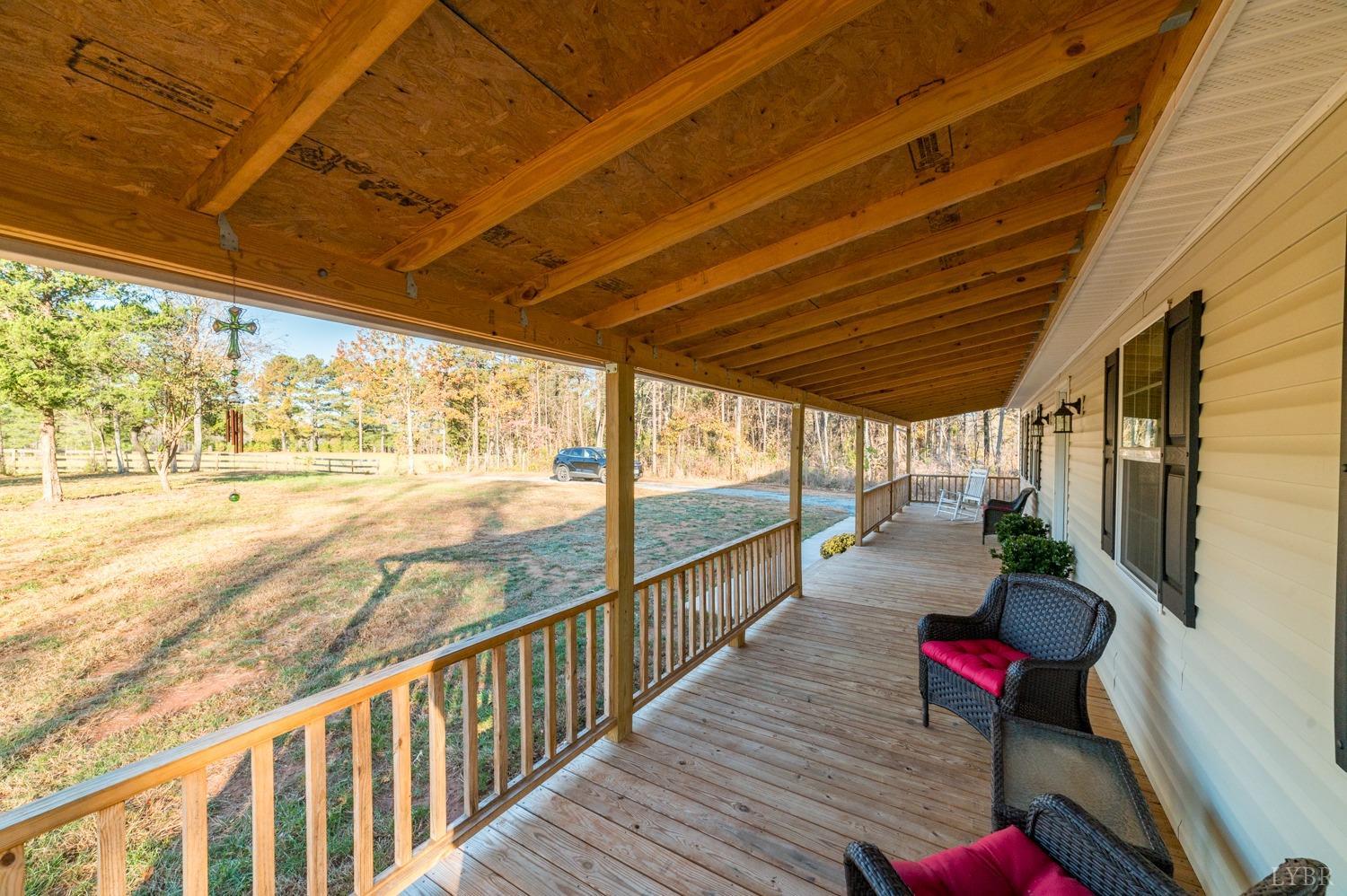 538 Spring Grove Road Spout Spring, VA 24593 - Photo 26 of 44 a balcony with chairs and wooden floor