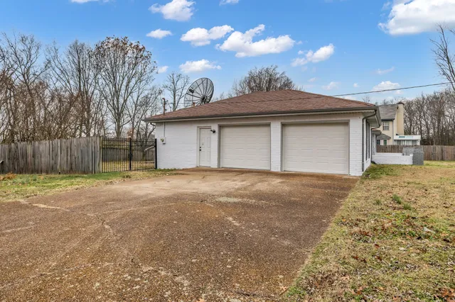 an empty room with wooden floor and fireplace
