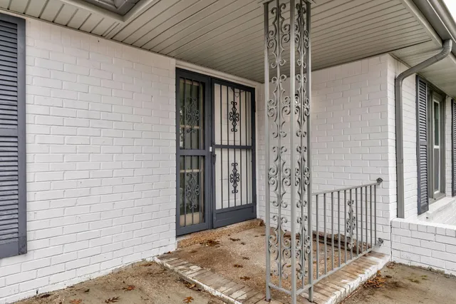 an empty room with wooden floor and window