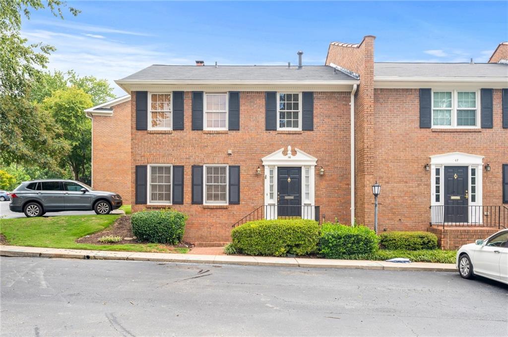 4620 Wieuca Road Northeast, Unit 66 Atlanta, GA 30342 - Photo 1 of 1 a front view of a house with a garden and parking