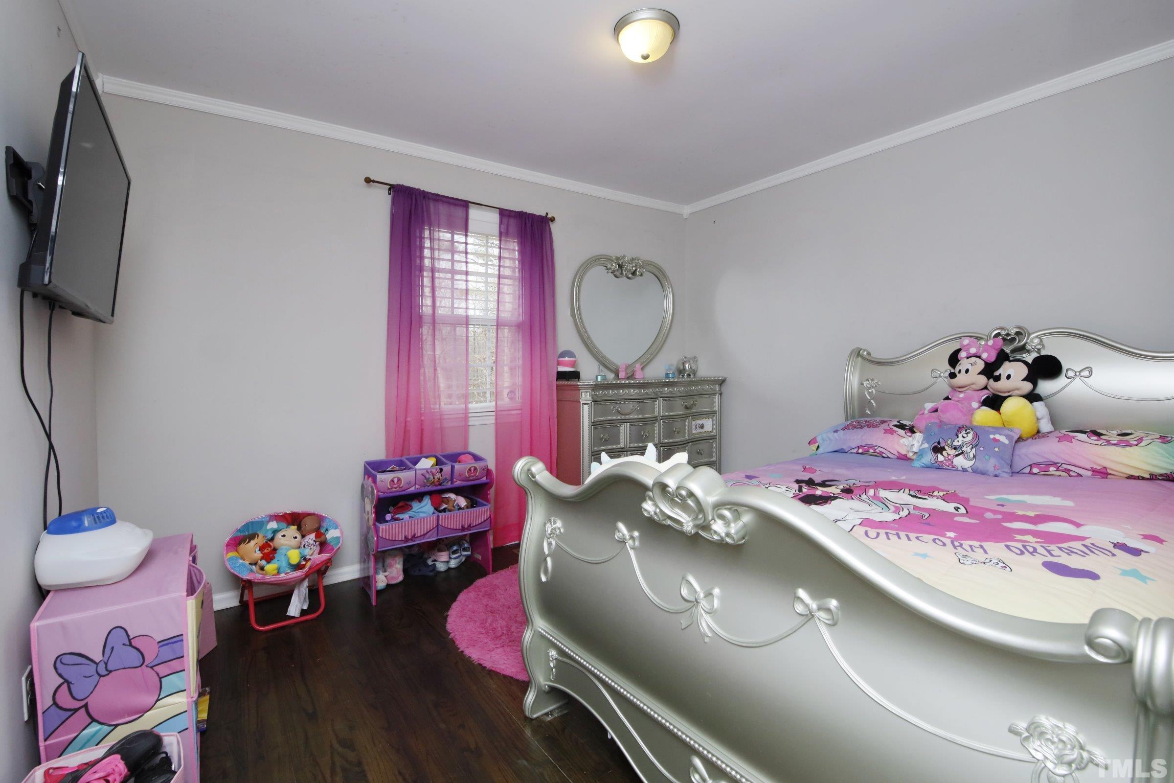 6120 Guess Road Durham, NC 27712 - Photo 16 of 22 a bedroom with furniture and a wooden floor