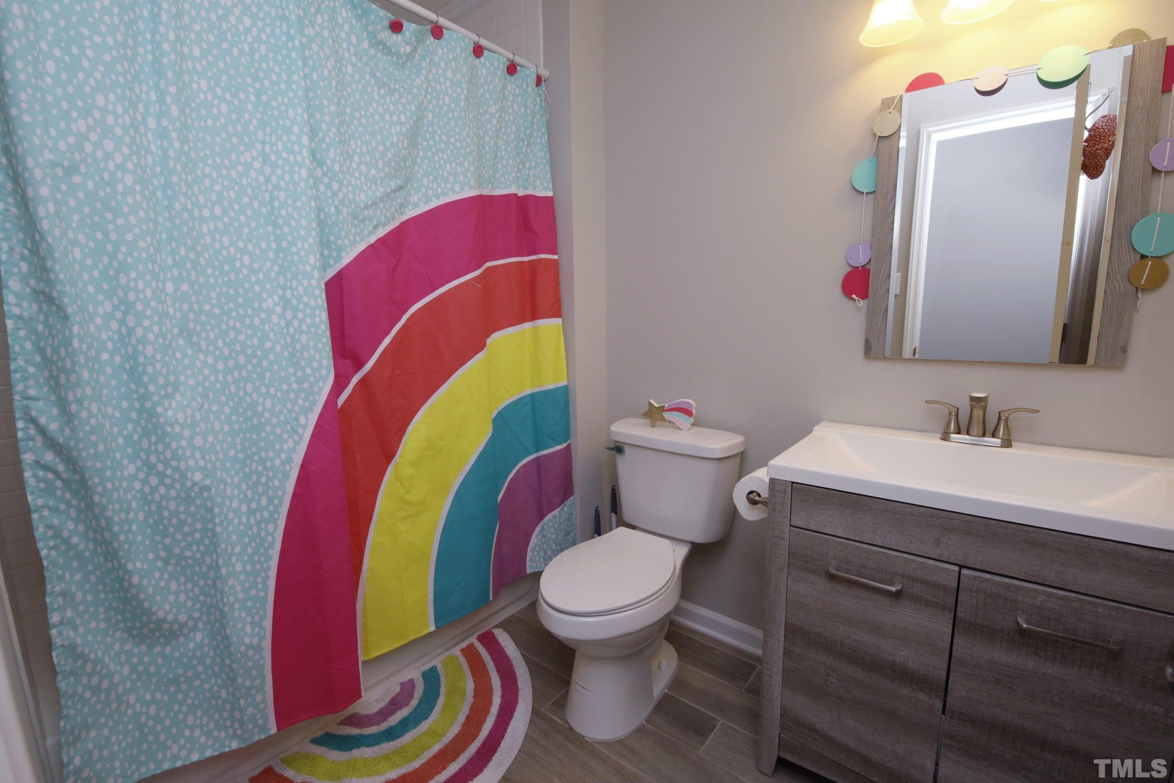 6120 Guess Road Durham, NC 27712 - Photo 17 of 22 a bathroom with a sink mirror vanity and toilet